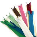 A collection of invisible zippers tied to a flat surface featuring zippers in navy blue, blue, green, lime green, pink, red, brown, and white.