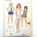 A Butterick sewing pattern for kids' dress and bloomers, showing illustrations of two dresses and a pair of bloomers, with measurements and fitting instructions.