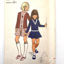 A cover image of a Butterick kids' dress and jacket pattern showcasing an illustration of two children wearing the finished product. 