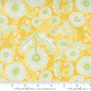 Fabric pattern with green floral designs on a yellow background, featuring Moda label.