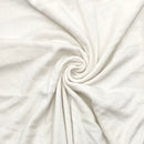 Close-up of white fabric with a swirl pattern