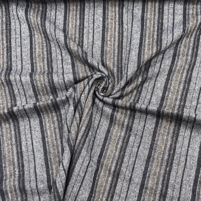 A close-up of a black and grey striped fabric scrunched into a swirl design.