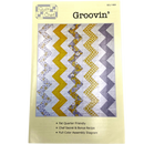 A paper quilt pattern for a modern quilt design named 'Groovin'', featuring a grid of diamonds and triangles in various colors.