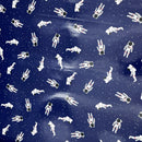 PUL fabric with A repeating pattern of white astronauts floating on a dark navy blue background with small white stars.
