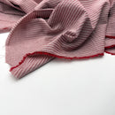 Italian deadstock Pink and red striped cotton lawn fabric on a white background