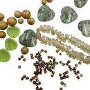 Various stone and glass beads arranged on a white background.