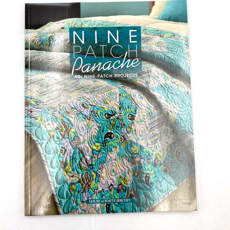 Front cover of book featuring a 9 patch quilt.