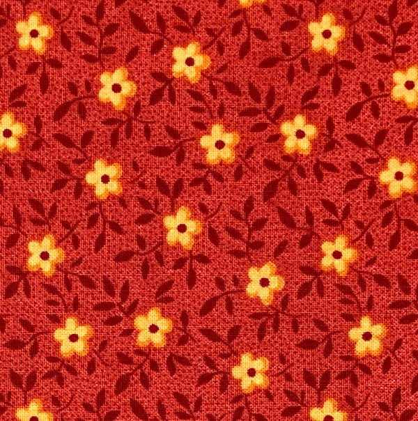 Little orange flowers with dark red vines and tiny polka dots on a red background.