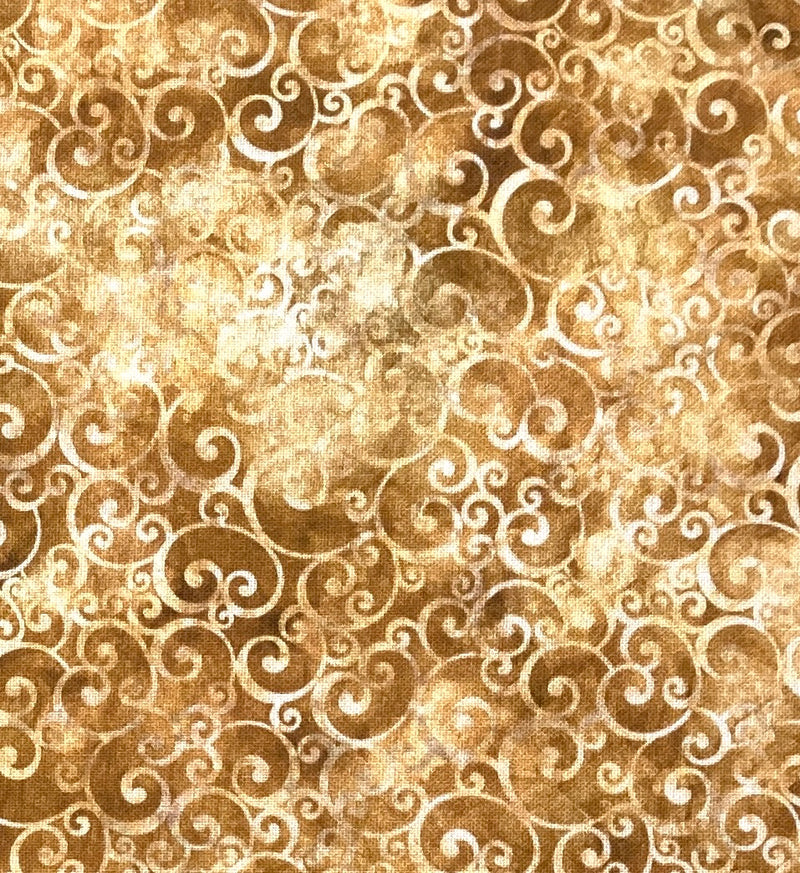 Tan swirls on brown fabric