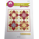 A quilt pattern booklet cover for 'I Like Big Blooms' by Charisma Horton, showing a quilt with a variety of geometric shaped patches in red, gray, and yellow with floral designs.