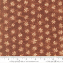 Floral patterned fabric with a ruler at the bottom for scale, on a brown background.