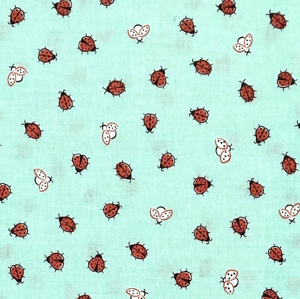 Red and white ladybugs on a mint green background