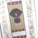 A quilted wall hanging featuring a turkey with a pilgrim hat in a striped background, titled ' Where's The Beef?'