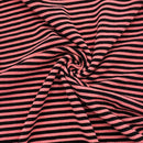 Pink and black striped fabric in a swirl pattern