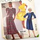 A second-hand McCall's sewing pattern for a misses' dress and tie belt, showing illustrations of the finished dresses on the cover.