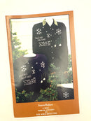 A paper crafting pattern for making a snowflake design on a sweatshirt, from the Primitive Stitchery Old World Reflections collection, with a visual example of a completed snowflake design on a sweatshirt displayed on a mannequin.