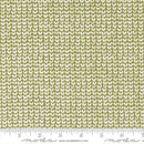 Fabric pattern with white geometric shapes on a green background, featuring Moda label.