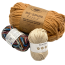 Three skeins of different types of yarn. One is labeled 'Re-spun' made of 100% recycled polyester, the second is a multicolored blend, and the third is beige.