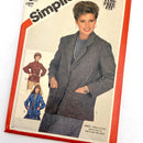 A cover of a Simplicity magazine featuring a model wearing a double-breasted, V-neck jacket with patterned fabric. The magazine is from the UK, size 12, and the cover shows the text 'Simplicity' and 'Simple Fit'.
