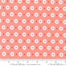 Fabric pattern with white flowers and red dots on a pink background, featuring Moda label.