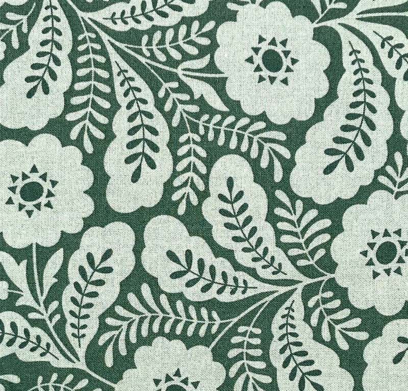 A quilting cotton fabric in a calming spruce green color with lighter green geometric floral designs. 