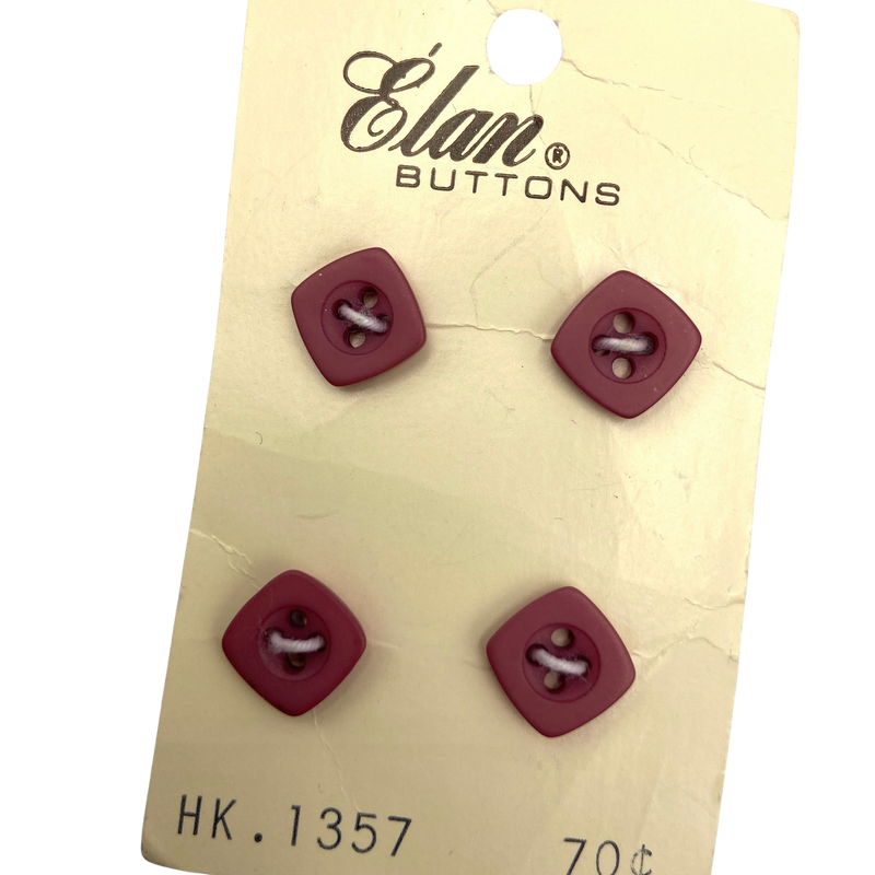 A set of 4 red, square, plastic buttons.