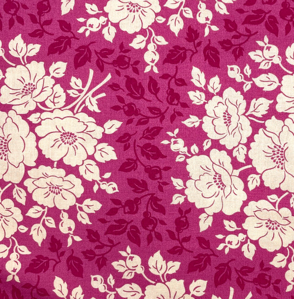 A 100% cotton quilting fabric with floral designs in shades of deep pink and ivory.