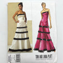The image shows the cover of a sewing pattern for an adult dress, featuring a white and pink dress on the left and a black and pink dress on the right. The pattern is labeled 'Tom and Linda Platt' and has the V2930 number.