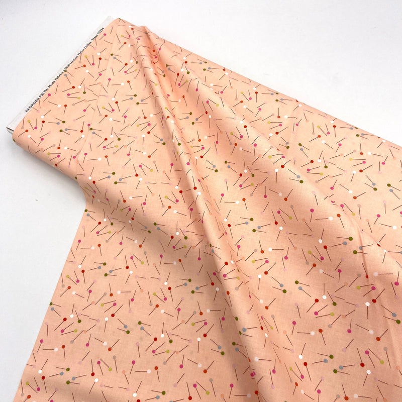 Peach quilting fabric with scattered pins