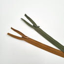 Two 25-inch invisible zippers, one brown and one green, laid out on a white background.