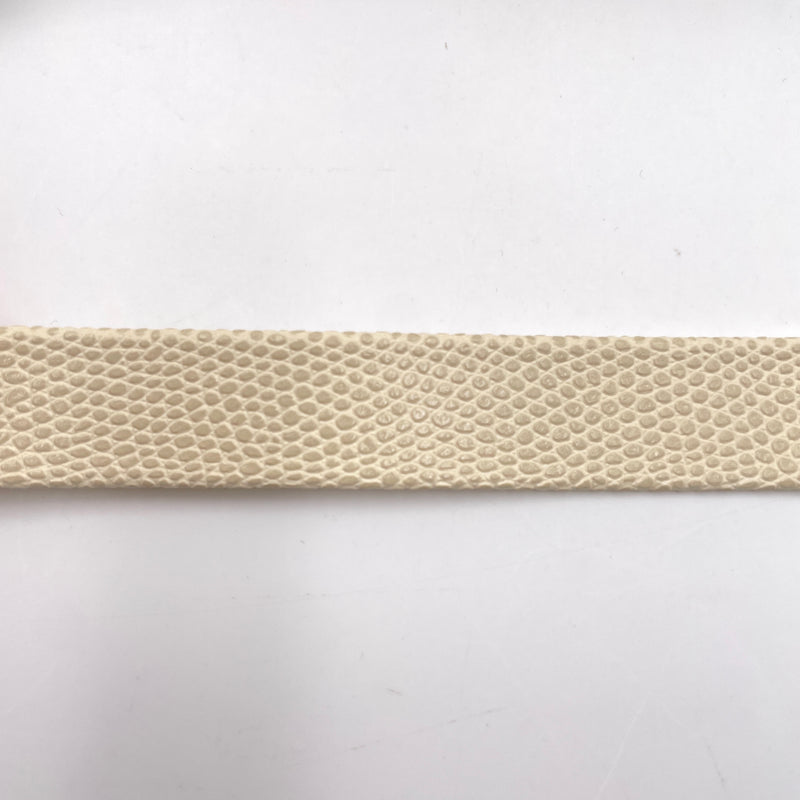 A close-up of beige trim with an obvious snakeskin texture. 